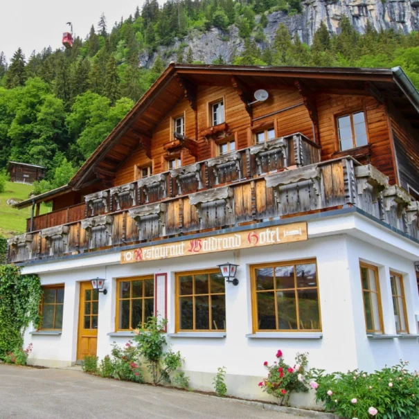Sonnenterrasse und Eingang des traditionsreichen Chalet Hotel & Restaurant Waldrand in Isenfluh, Jungfrau Region.